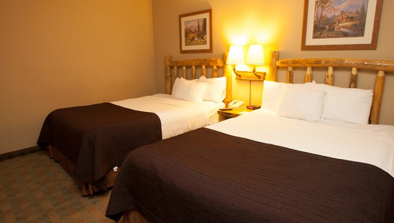 The queen beds in the Grizzly  Bear Suite